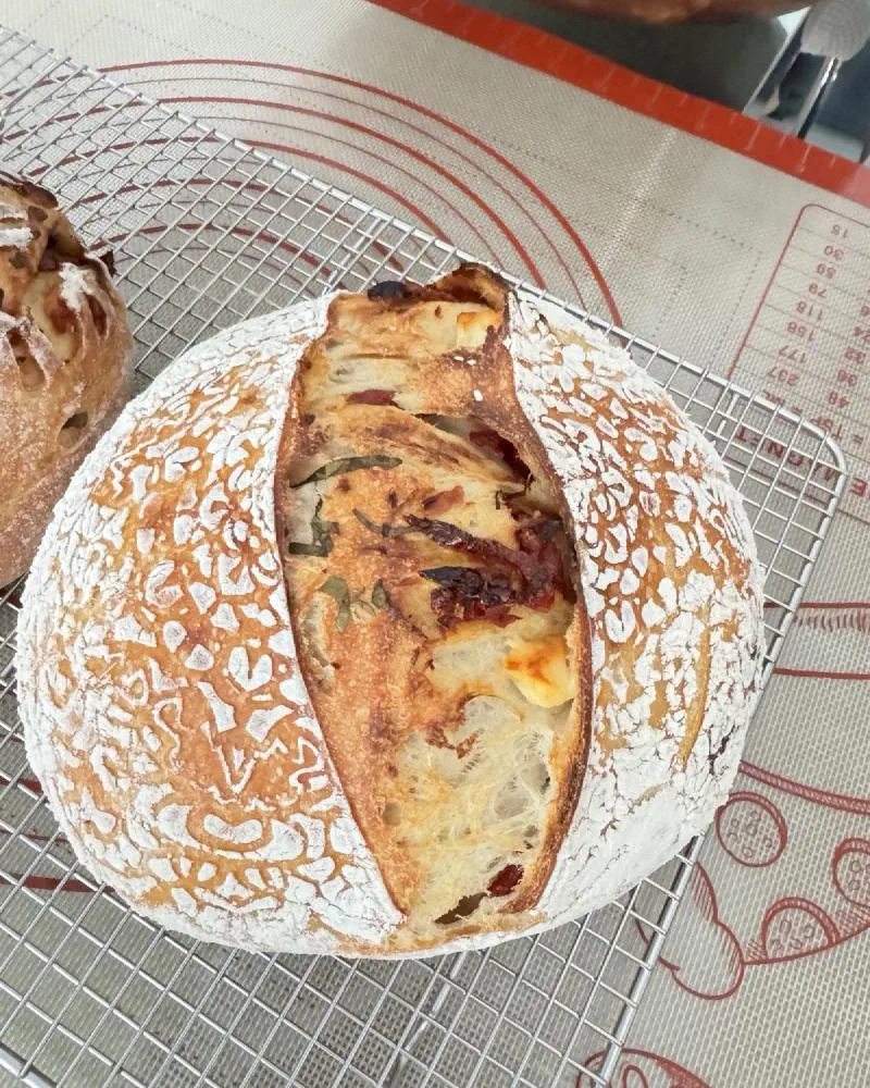 A Feta than Ever loaf split open to show sun-dried tomato, basil and feta